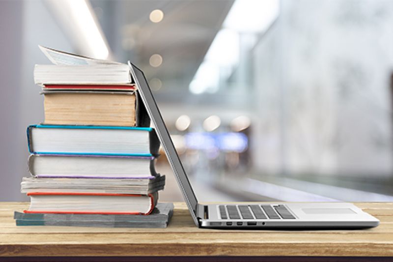 laptop leaning on books - planning advisory notes