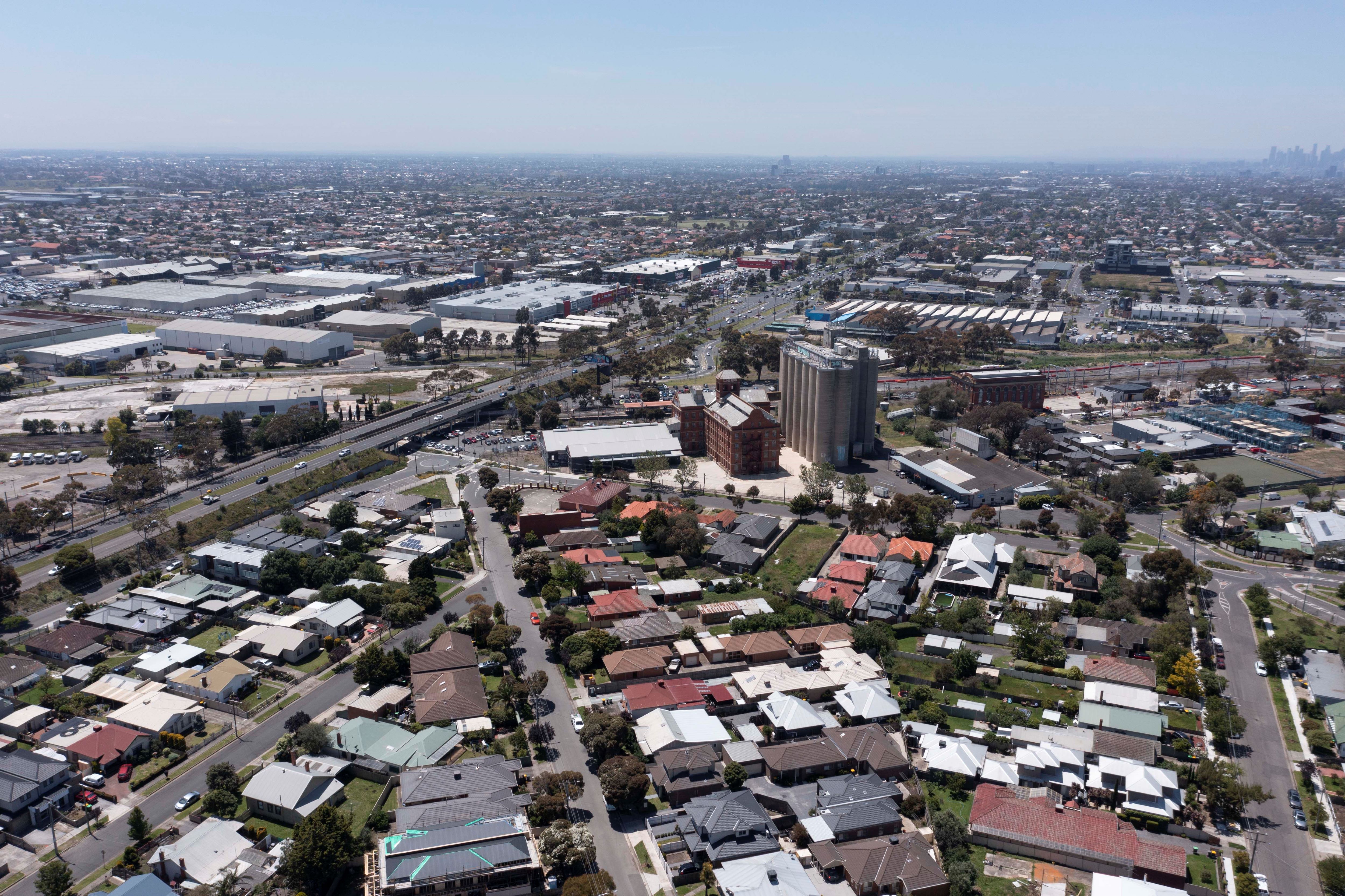 An aerial view of suburban streets and rooftops.